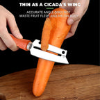 Wooden handle peeler knife taking a thin peel off a carrot