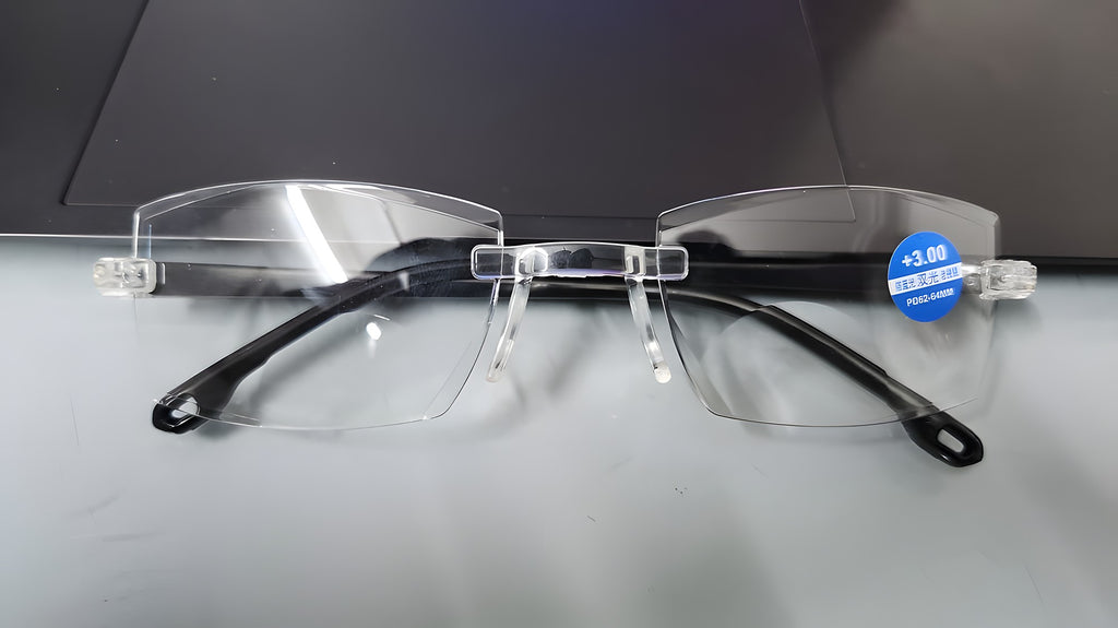 Rimless reading glasses with +3.00 power sticker on the lens